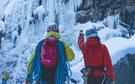 Personnes de dos qui s'apprêtent à escalader une cascade de glace